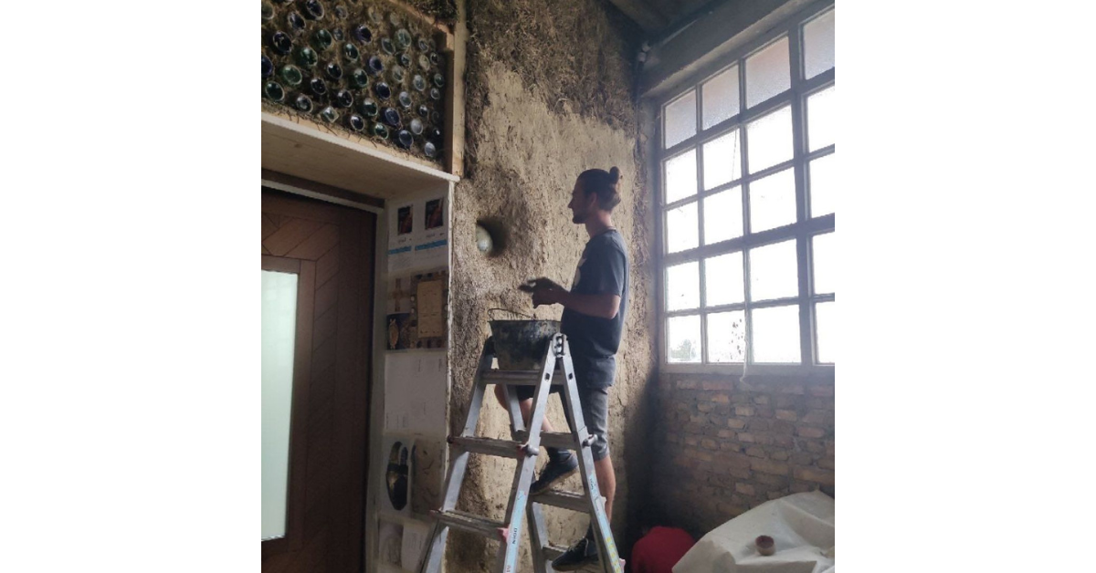 volunteer doing wall work
